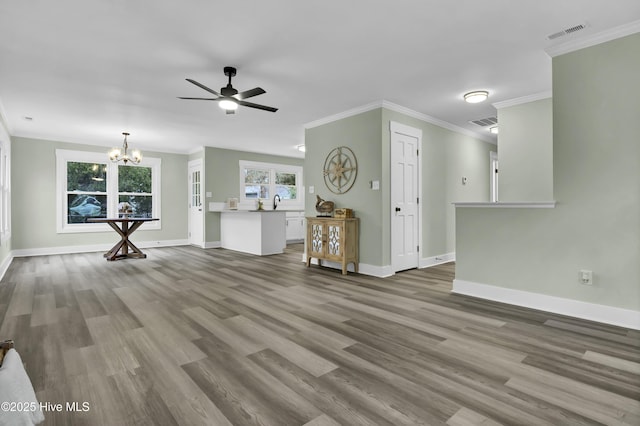 unfurnished living room with hardwood / wood-style flooring, ceiling fan with notable chandelier, and ornamental molding