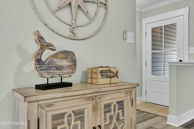 interior details with hardwood / wood-style floors and ornamental molding