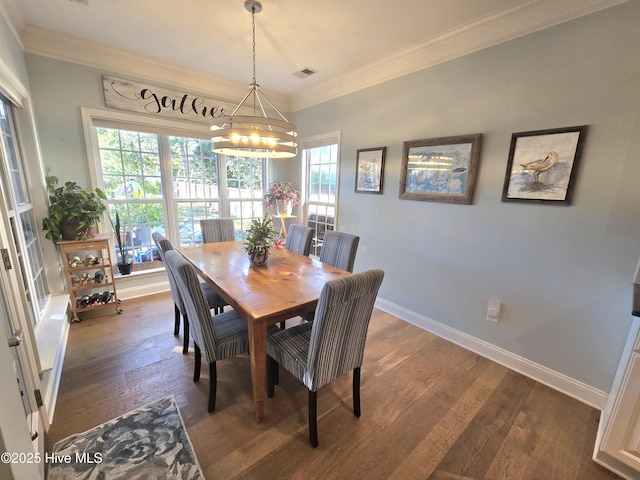 dining room with visible vents, dark wood-type flooring, crown molding, baseboards, and a chandelier