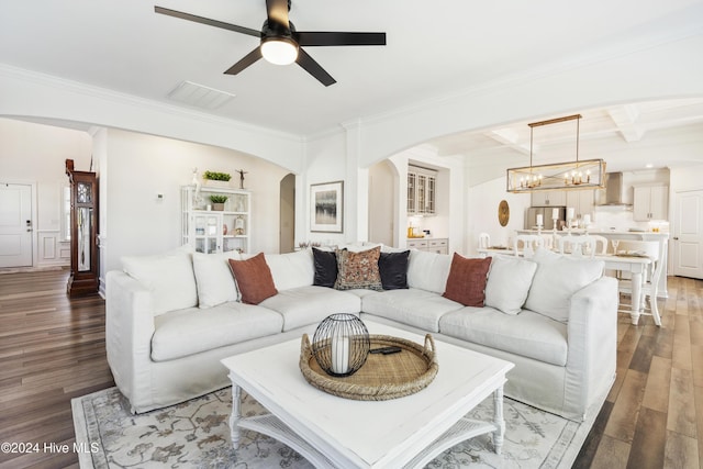 living room with beamed ceiling, coffered ceiling, visible vents, and wood finished floors