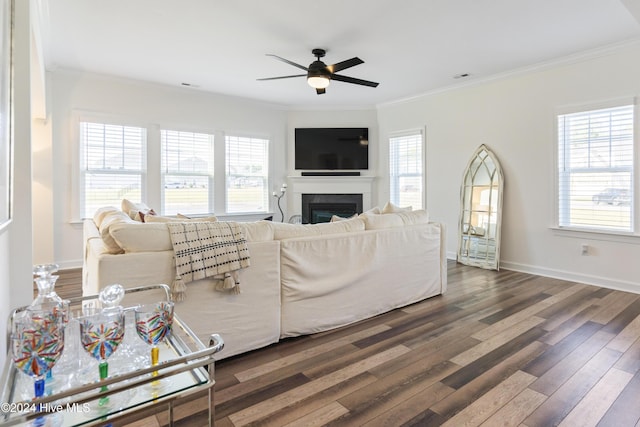 living room with ceiling fan, ornamental molding, and a healthy amount of sunlight