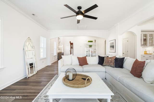 living room featuring ceiling fan, dark wood-type flooring, and ornamental molding