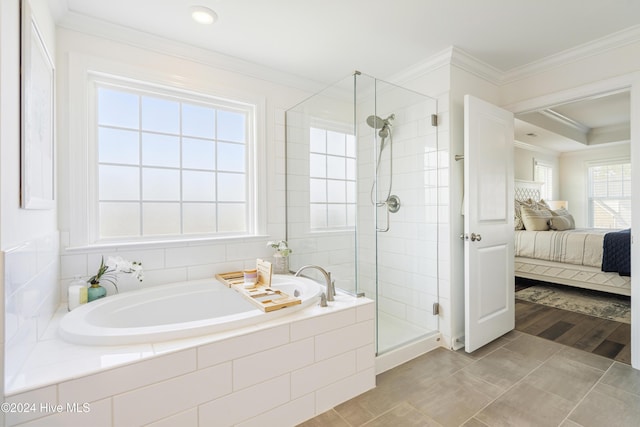 ensuite bathroom featuring connected bathroom, a stall shower, crown molding, and a bath