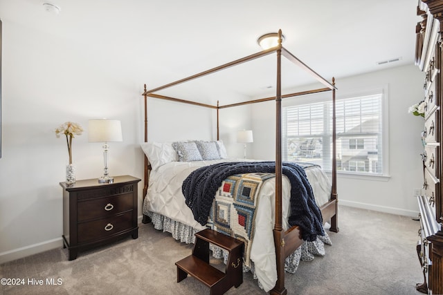 bedroom with visible vents, carpet flooring, and baseboards