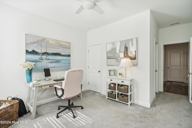 carpeted office with ceiling fan