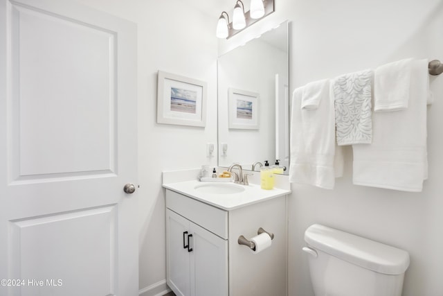 bathroom featuring toilet and vanity