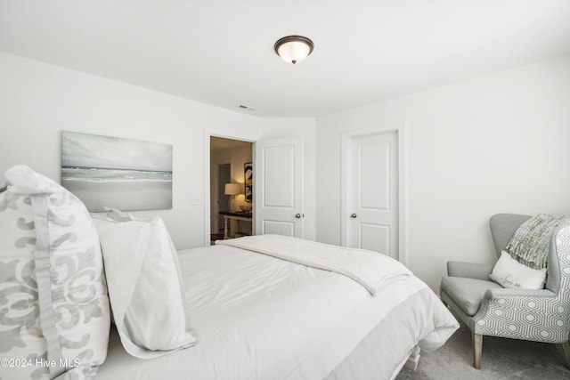 bedroom featuring carpet flooring and visible vents