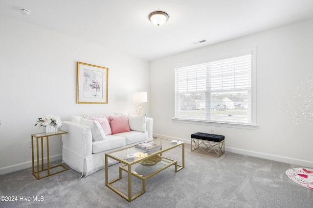 living room with carpet flooring, baseboards, and visible vents