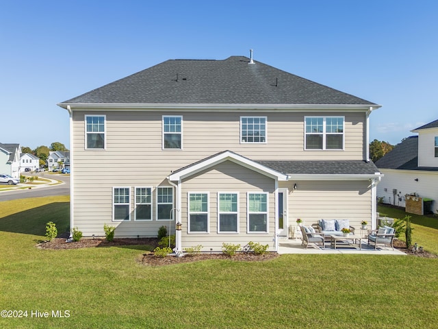 back of house featuring an outdoor living space, a lawn, a shingled roof, and a patio area