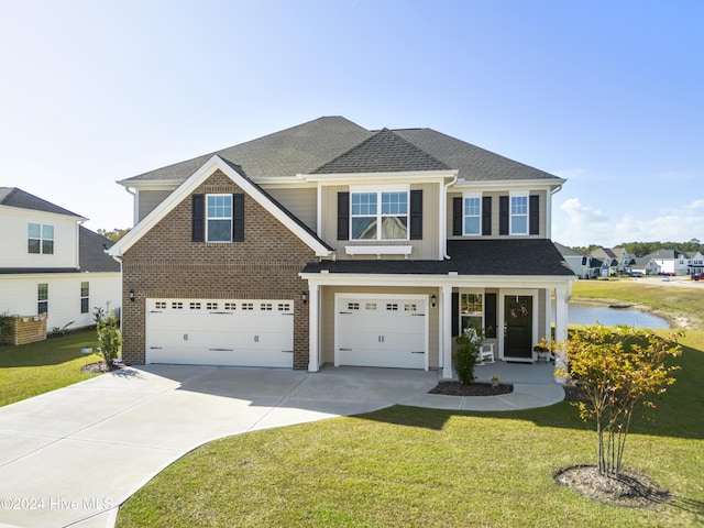 view of front of house with brick siding, driveway, a front lawn, and an attached garage