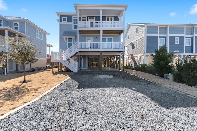 rear view of property featuring a carport and a balcony