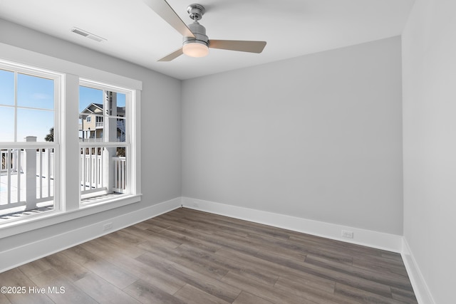 empty room with hardwood / wood-style floors and ceiling fan