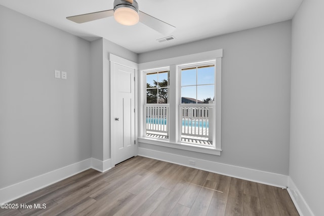 spare room with ceiling fan and light hardwood / wood-style floors