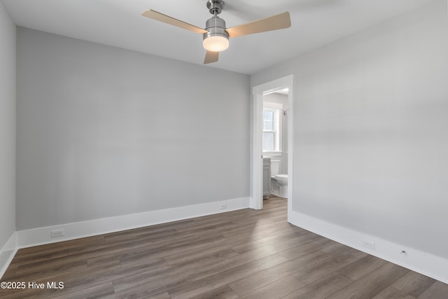 empty room featuring ceiling fan and dark hardwood / wood-style flooring