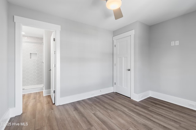 unfurnished bedroom featuring wood-type flooring and ceiling fan