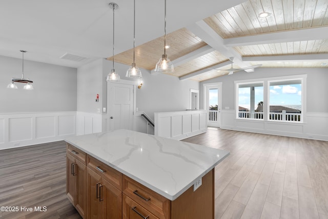 kitchen featuring a center island, hardwood / wood-style floors, hanging light fixtures, and wooden ceiling