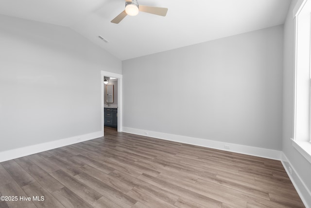 unfurnished room featuring ceiling fan, lofted ceiling, and light hardwood / wood-style flooring