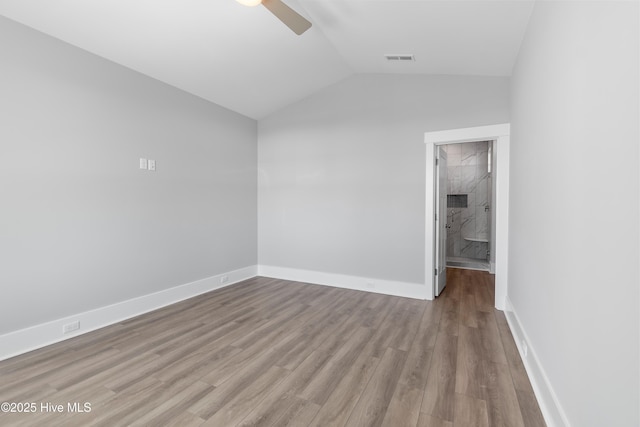 spare room with ceiling fan, lofted ceiling, and light hardwood / wood-style floors