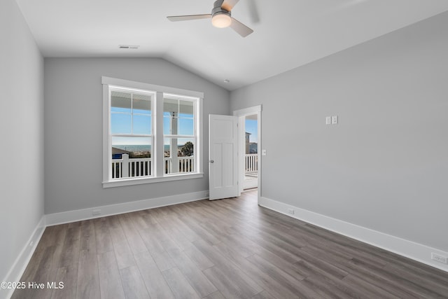 spare room featuring lofted ceiling, hardwood / wood-style floors, and ceiling fan