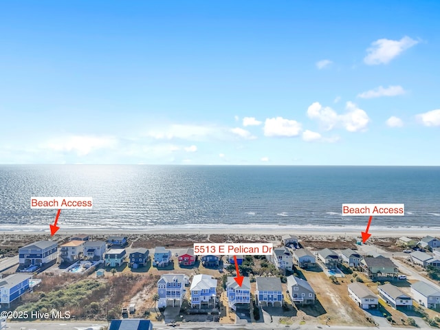 drone / aerial view featuring a view of the beach and a water view