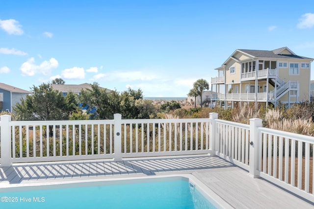 view of swimming pool featuring a deck