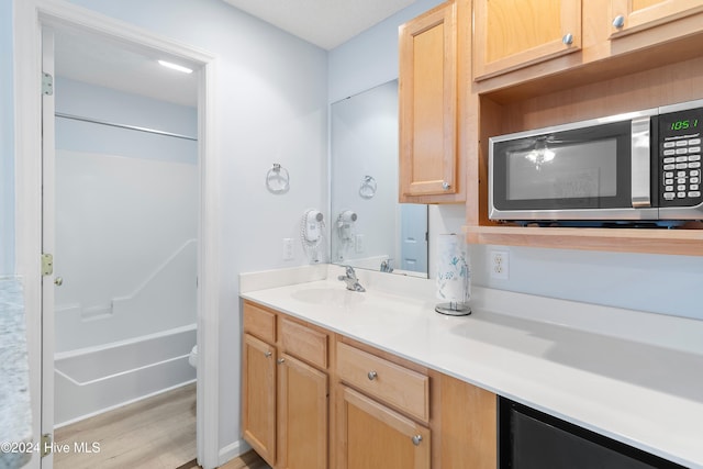 bathroom featuring vanity, hardwood / wood-style flooring, and toilet