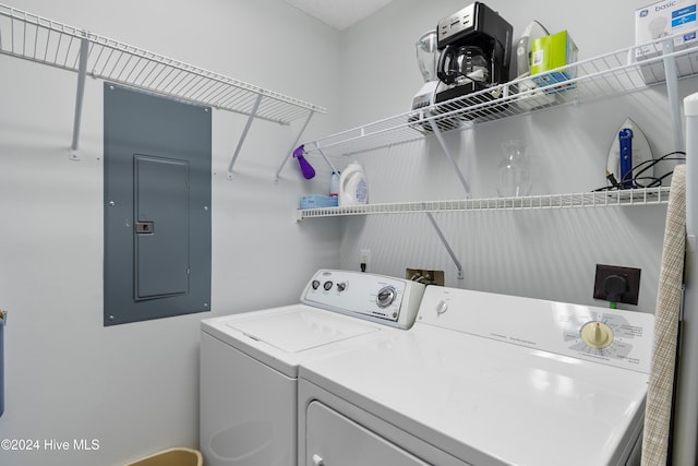 laundry room featuring electric panel and washing machine and dryer