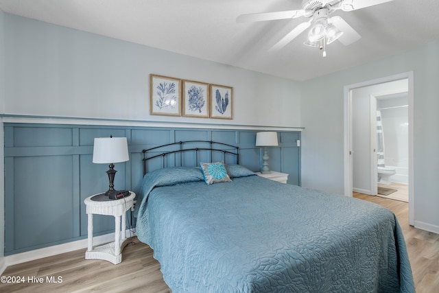 bedroom featuring ceiling fan, hardwood / wood-style floors, and ensuite bathroom