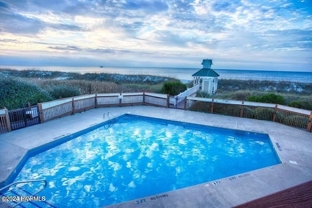 view of pool featuring a water view