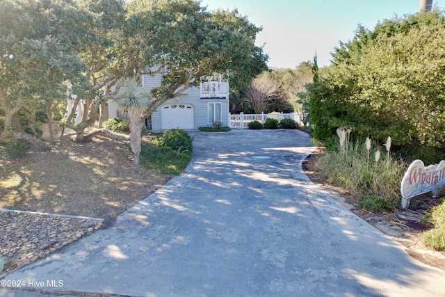 exterior space with a garage and a balcony