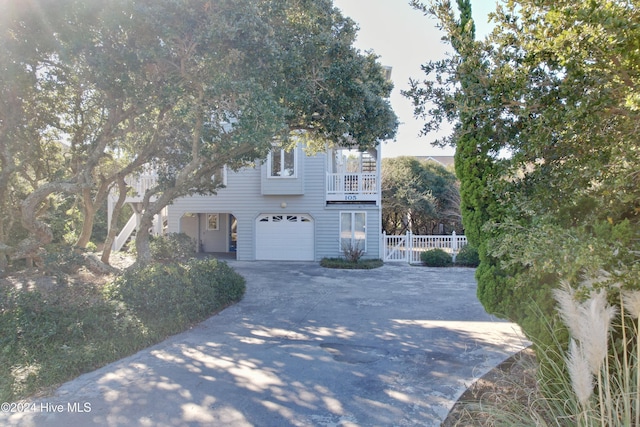 view of front of property with a balcony and a garage