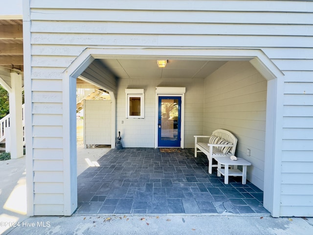 view of exterior entry featuring a patio