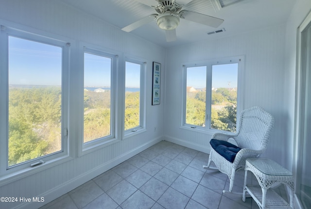 unfurnished room with ceiling fan, a healthy amount of sunlight, and light tile patterned flooring