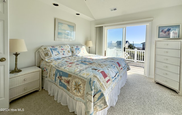 bedroom featuring access to outside, light colored carpet, and vaulted ceiling