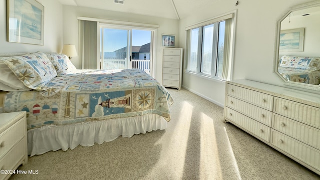 carpeted bedroom featuring access to outside and vaulted ceiling