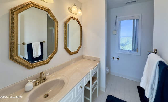 bathroom featuring tile patterned floors, vanity, and toilet