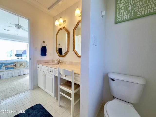 bathroom with tile patterned flooring, ceiling fan, toilet, and vanity