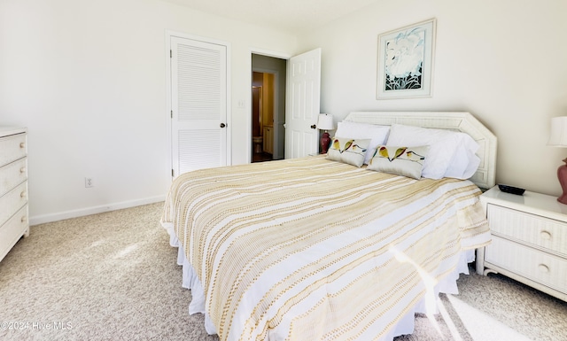 bedroom with light carpet and a closet