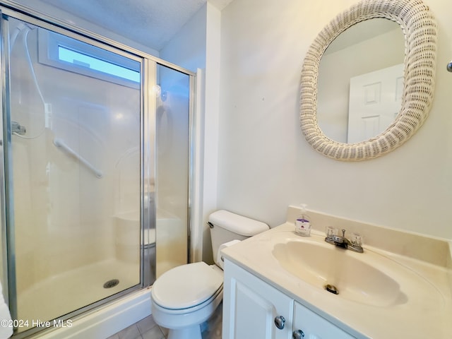 bathroom with tile patterned floors, a textured ceiling, vanity, toilet, and a shower with shower door