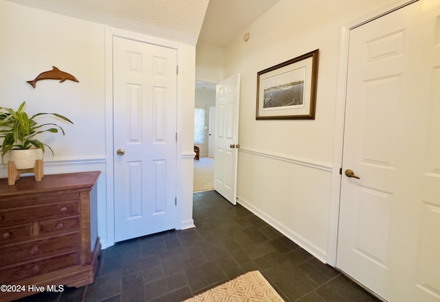 hall with a textured ceiling