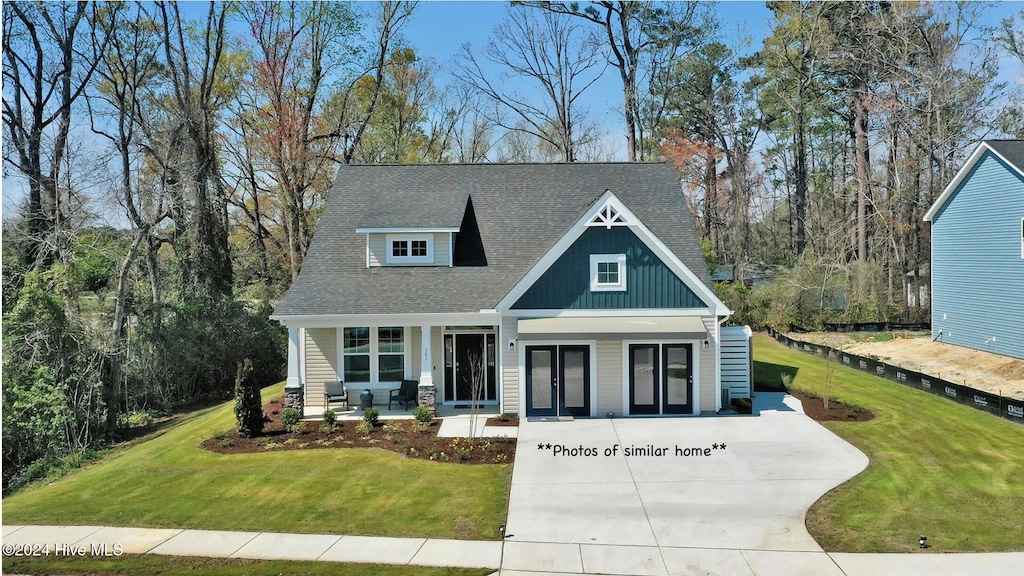 craftsman house featuring a front yard and covered porch