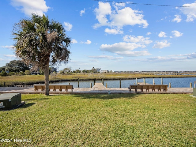 dock area with a yard and a water view