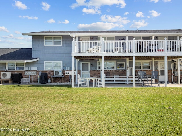 back of property featuring a lawn and ac unit