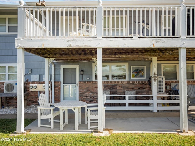 property entrance featuring ac unit, a balcony, and a patio area