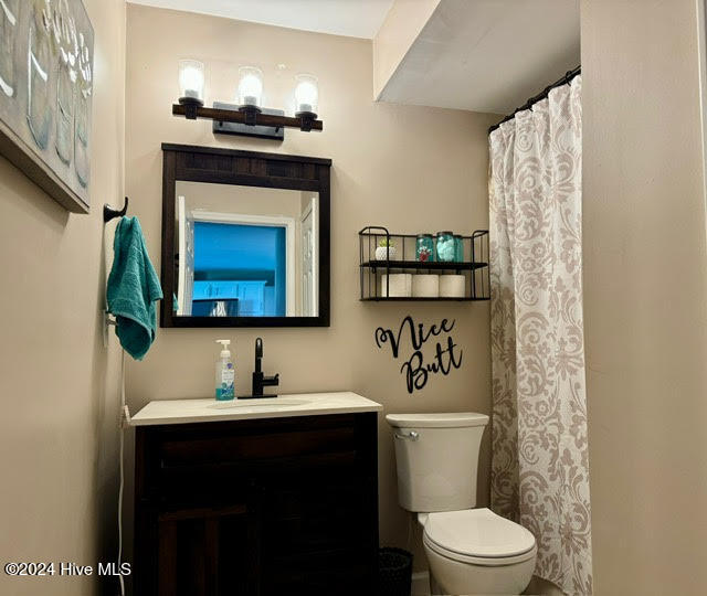 bathroom featuring toilet and vanity