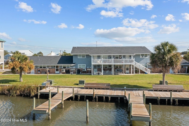 dock area featuring a water view and a yard