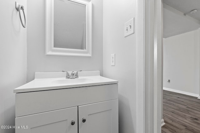 bathroom with hardwood / wood-style floors and vanity