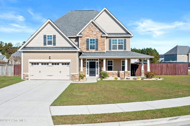 102 Hills Lorough Loop, Jacksonville, NC 28546 - craftsman-style home featuring stone siding, a garage, concrete driveway, a porch, and roof with shingles
