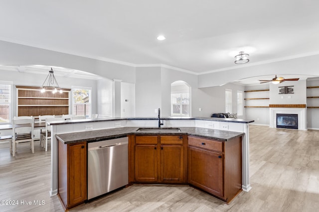 kitchen with dishwasher, sink, light wood-type flooring, a kitchen island with sink, and ornamental molding