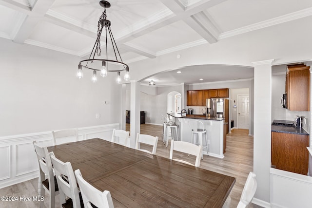 kitchen featuring decorative backsplash, light hardwood / wood-style flooring, crown molding, and appliances with stainless steel finishes